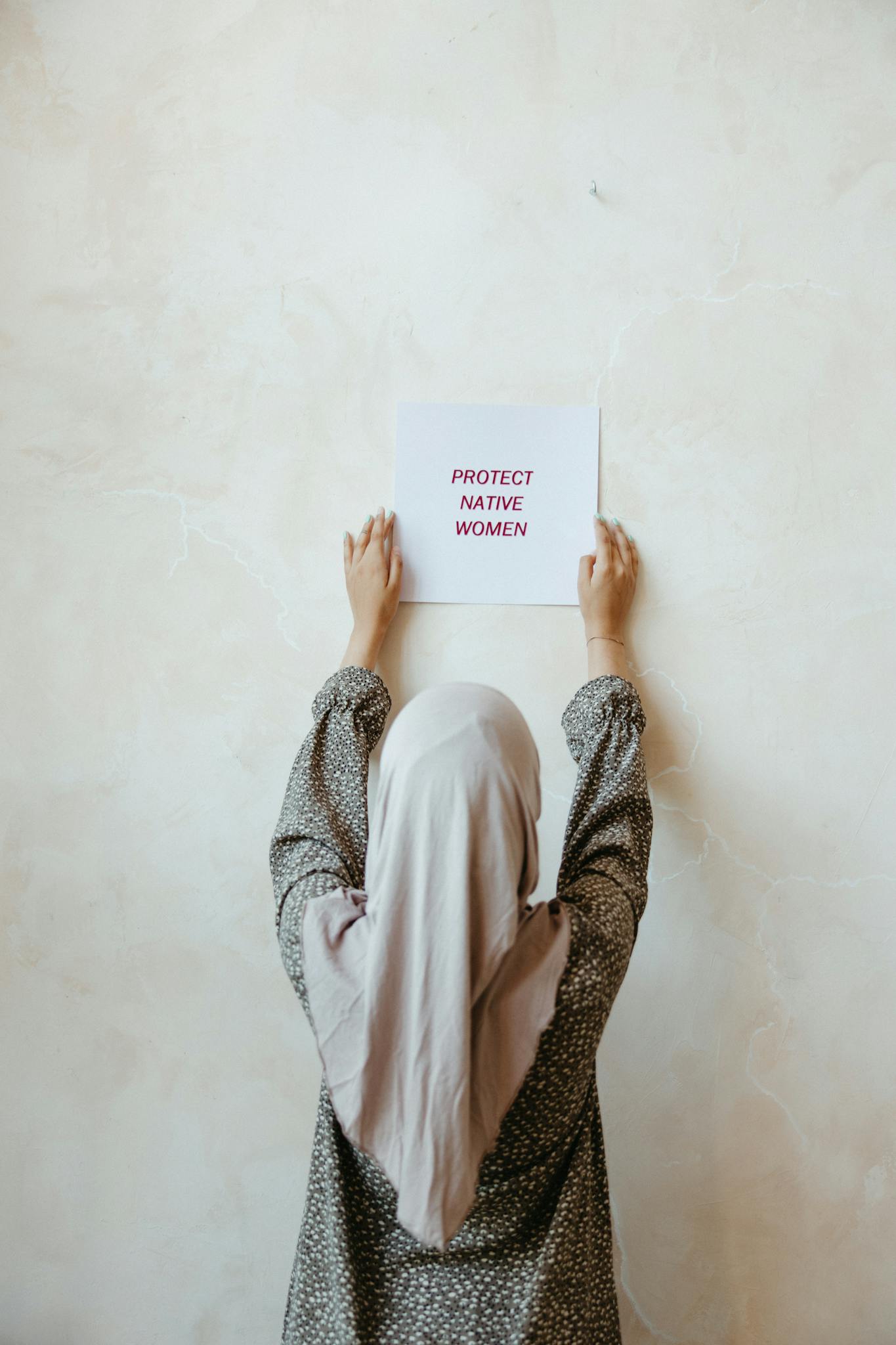 Woman In Hijab Holding A Protect Native